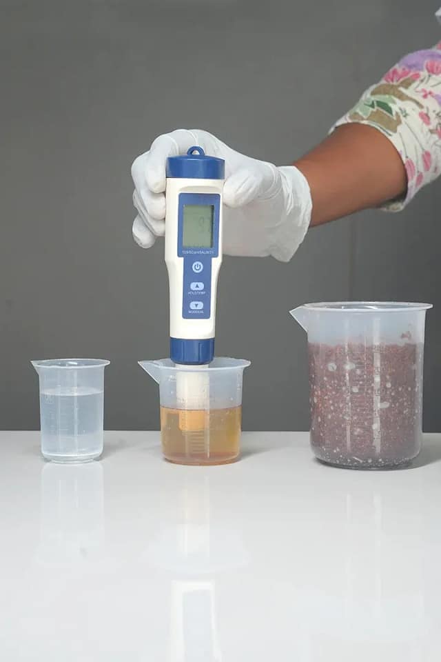 Digital meter testing the EC and pH of a coco coir substrate sample